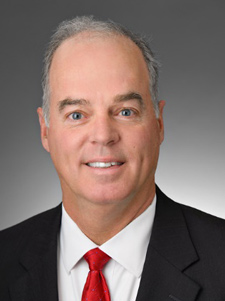 Headshot of Chris Joye in a suit and tie